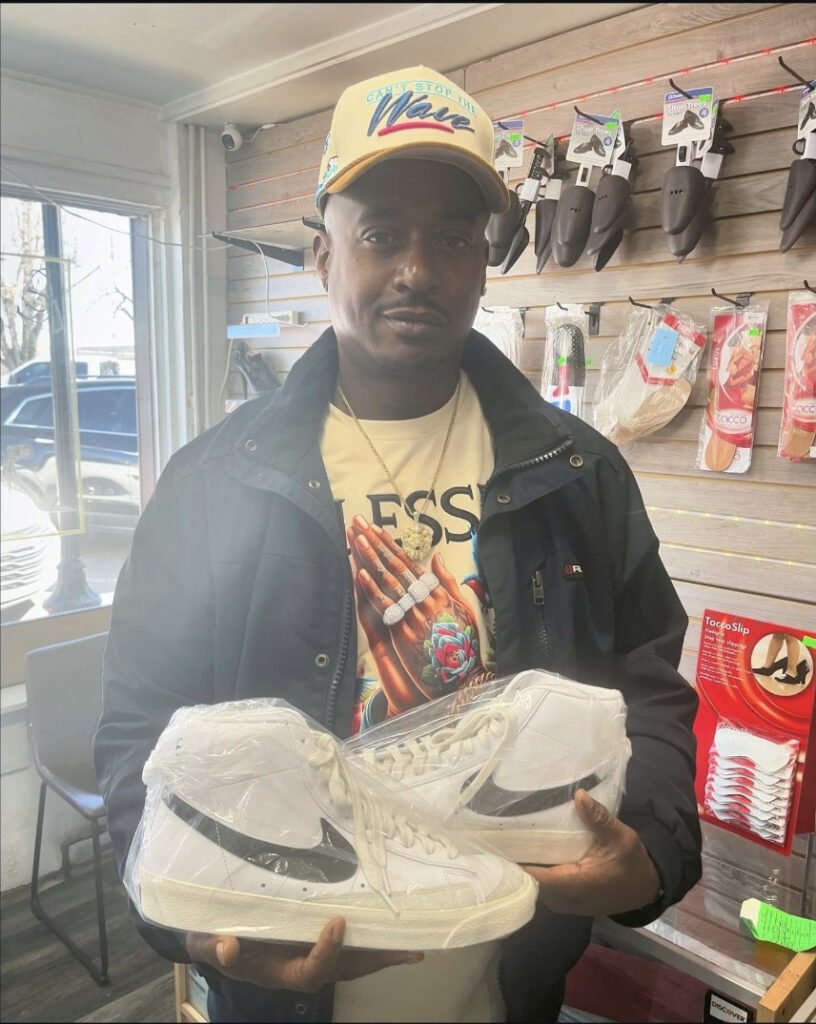 Customer with white sneakers at College Park Shoe Repair