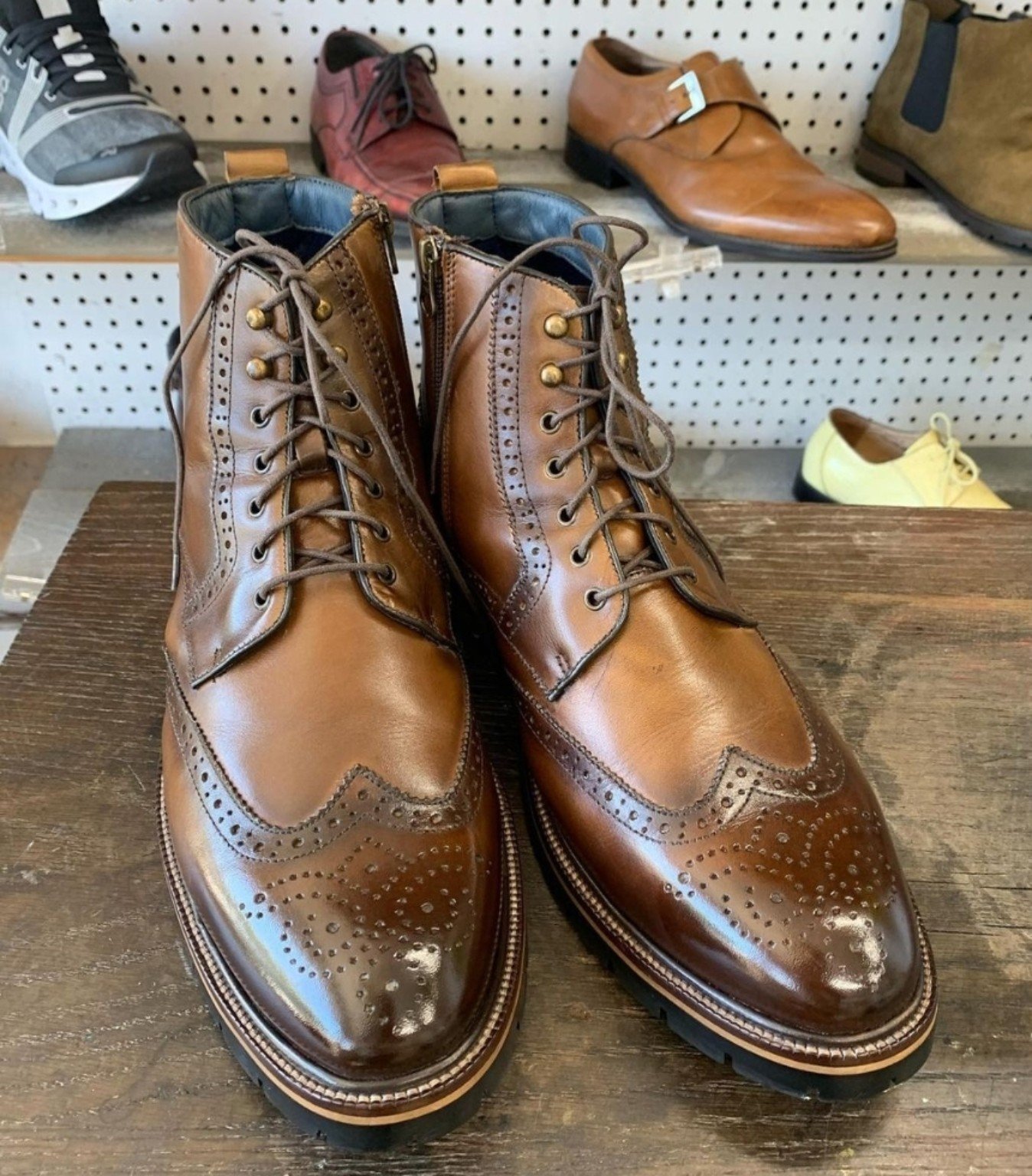 Men's brown leather wingtip boots at College Park Shoe Repair