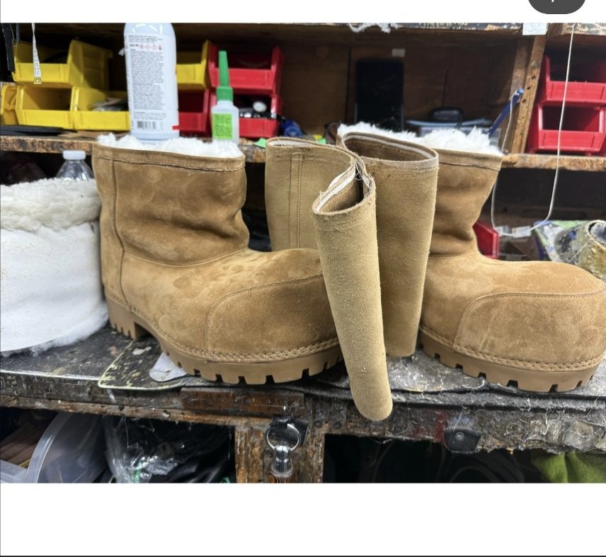 Cobbler modifying suede boots on the workbench at College Park Shoe Repair